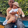 child, baby, siblings, outdoor, bench, greenery, smiling, cute, hood, casual_clothing, baby_bib, pacifier, happy, nature, candid, park, holding, portrait, people, family