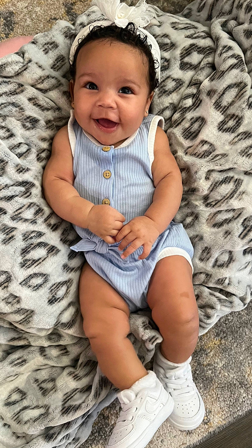 Amaia is registered to the contest to win money with this photo: baby, baby_toddler_clothing, beauty, child, cool, dress, face, facial_expression, grass, hairstyle, happy, iris, joy, leaf, person, photograph, skin, sleeve, smile, standing