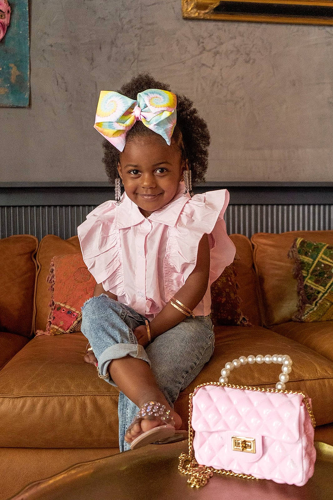 Nori is registered to the contest to win money with this photo: baby_toddler_clothing, child, comfort, couch, fashion_accessory, fun, hairstyle, happy, human_leg, joy, lap, living_room, pattern, person, picture_frame, room, sitting, sleeve, smile, sock