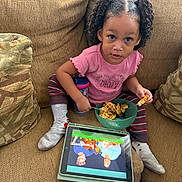 Azura joined the competition — help win amazing prizes! toddler, child, curly_hair, pigtails, pink_shirt, striped_pants, socks, bowl, waffles, sippy_cup, ipad, cartoon, couch, pillows, indoor, snack_time, cute, curious, relaxed, home
