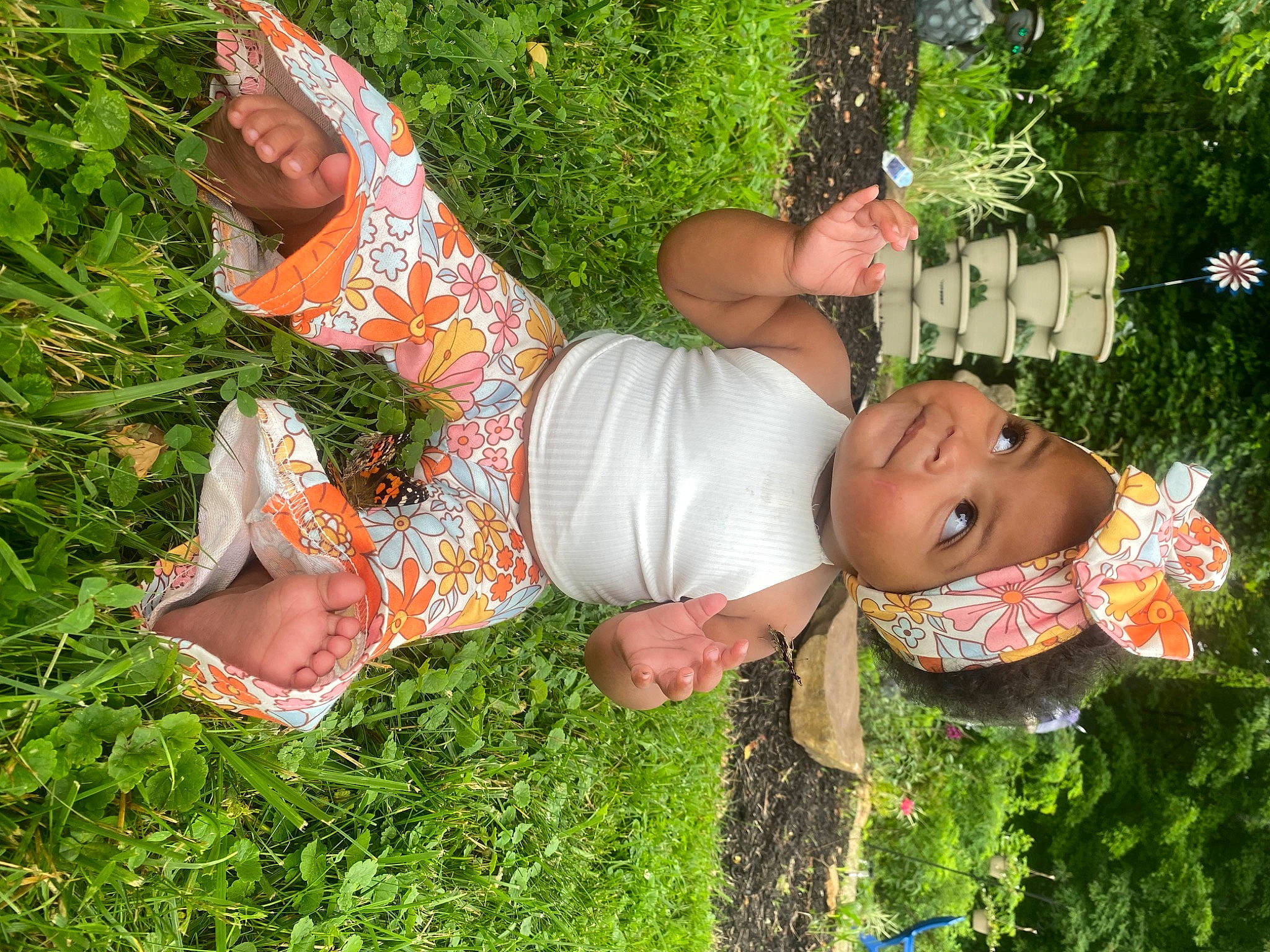 Oliana is registered to the contest to win money with this photo: chest, child, eyewear, fun, garden, grass, happy, hat, headwear, human_leg, lawn, lawn_ornament, leisure, people_in_nature, person, plant, shorts, shrub, t_shirt, thigh