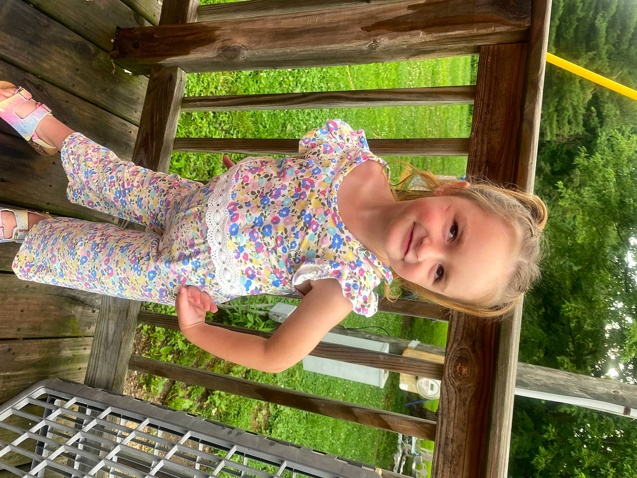 Heather is registered to the contest to win money with this photo: child, dress, foot, fun, grass, green, happy, human_leg, joy, leisure, pattern, people_in_nature, person, plant, sandal, sitting, smile, thigh, toddler, tree