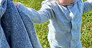 Jayce joined the competition — help win amazing prizes! toddler, child, grass, outdoor, field, sunny, daylight, grey_clothing, pajamas, person, holding, sweatshirt, nature, suburban, houses, curious, young_child, blond_hair, standing, casual