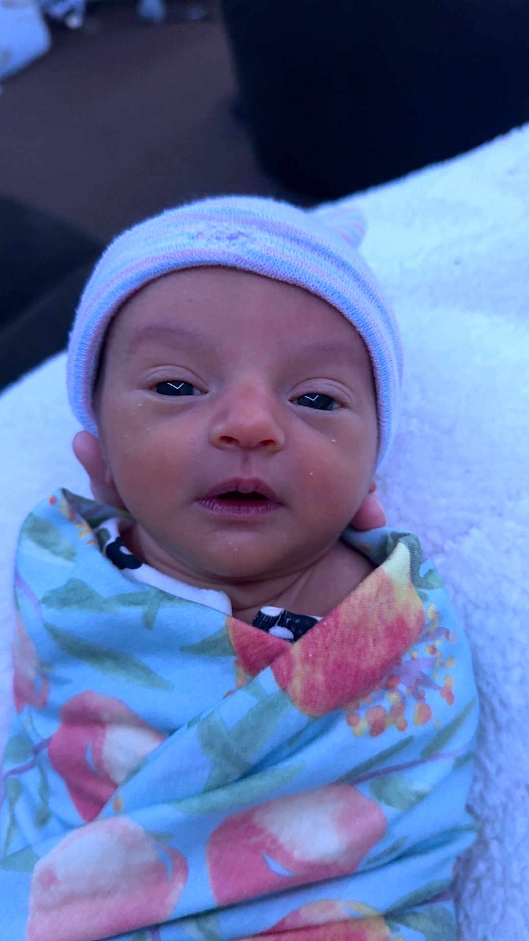 Rayleigh joined the competition — help win amazing prizes! newborn, baby, infant, wrapped, blanket, hat, sleepy, face, portrait, cozy, cute, child, person, soft, resting, closeup, indoor, colorful, floral, swaddled