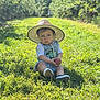 toddler, child, hat, apple, grass, outdoor, nature, greenery, sunlight, orchard, baby, clothing, footwear, portrait, sitting, summer, daytime, cute, young_child, casual