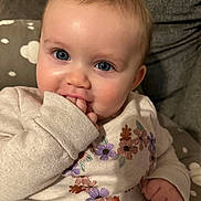 Charlie joined the competition — help win amazing prizes! baby, child, face, blue_eyes, sweater, flowers, hand, fingers, cushion, cloud_pattern, cozy, cute, indoor, portrait, closeup, skin, cheeks, infant, person, young