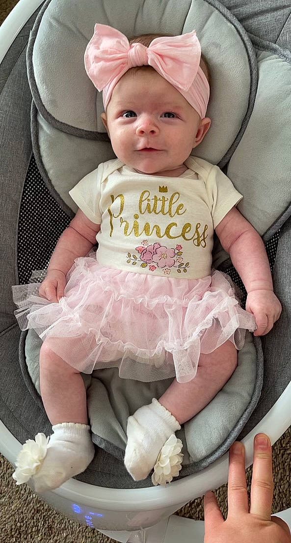 Briley joined the competition — help win amazing prizes! baby, baby_products, baby_safety, baby_toddler_clothing, cap, chair, cheek, child, comfort, fashion_accessory, headwear, leg, pattern, person, pink, product, sitting, sleeve, smile, sock