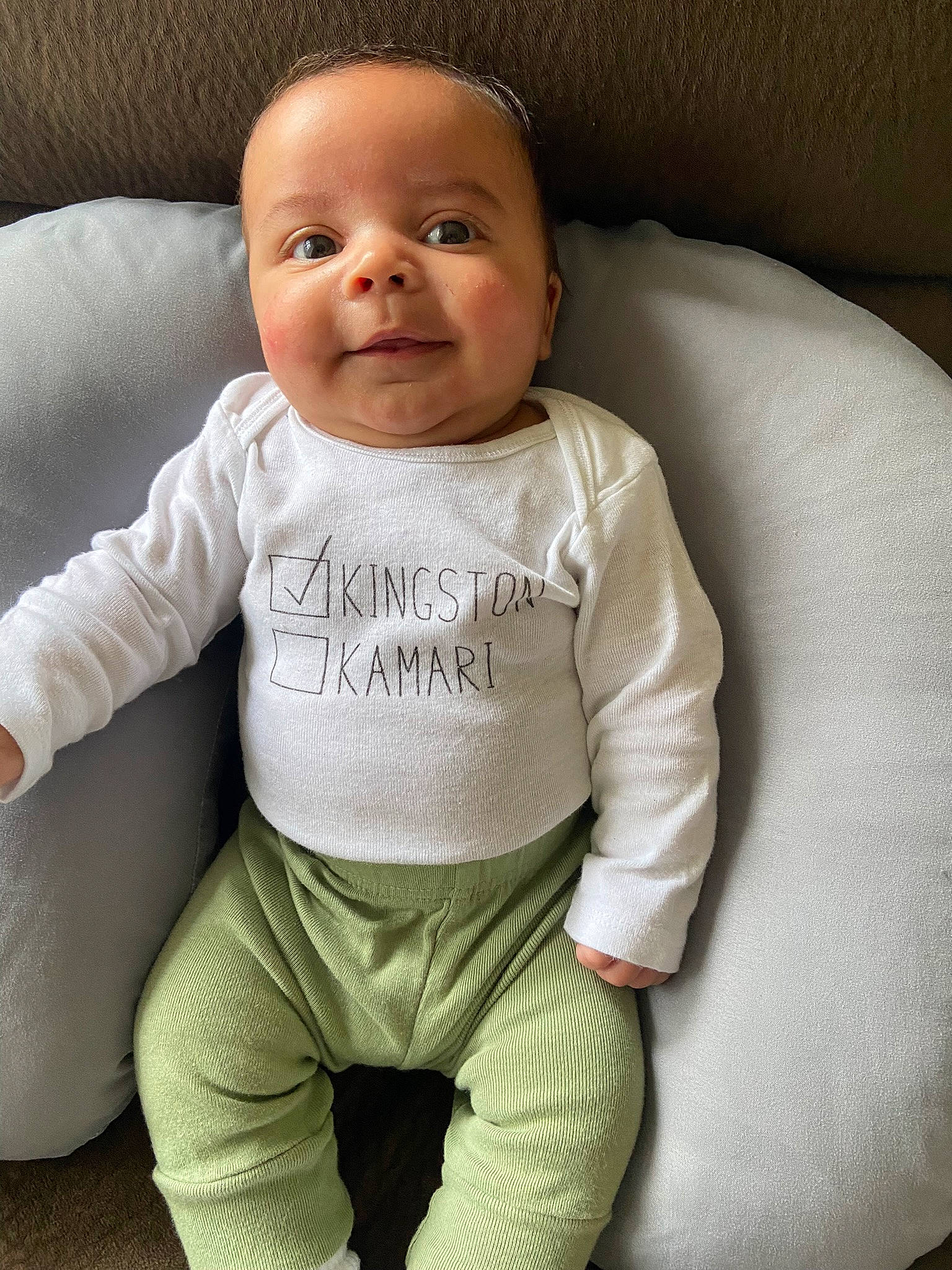 Kingston is registered to the contest to win money with this photo: baby, baby_toddler_clothing, cheek, chin, comfort, eye, face, gesture, happy, head, human_body, iris, neck, nose, person, product, skin, sleeve, smile, textile