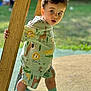 toddler, child, outdoor, playground, wood, post, animal_print, shorts, shirt, curly_hair, socks, shoes, greenery, daylight, standing, expression, face, person, summer, playing