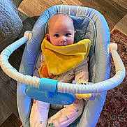 Grady joined the competition — help win amazing prizes! baby, blue_baby_seat, chewing, child, comfort, cozy, cute, face, frog_design, green_socks, home, indoor, infant, pajamas, rug, seated, smiling, toy_bar, wooden_floor, yellow_bib