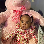 Amariaya is registered to the contest to win money with this photo: baby, child, comfort, cozy, cute, face, flower_pattern, furniture, headband, indoor, infant, pajamas, person, pink, plush_toy, portrait, seated, soft, teddy_bear, toy