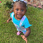 Eastlynn joined the competition — help win amazing prizes! toddler, child, grass, flowers, garden, outdoor, person, smiling, blue_shirt, colorful_clothing, hair_beads, pink_shoes, nature, greenery, young_child, playful, curious, daylight, portrait, casual