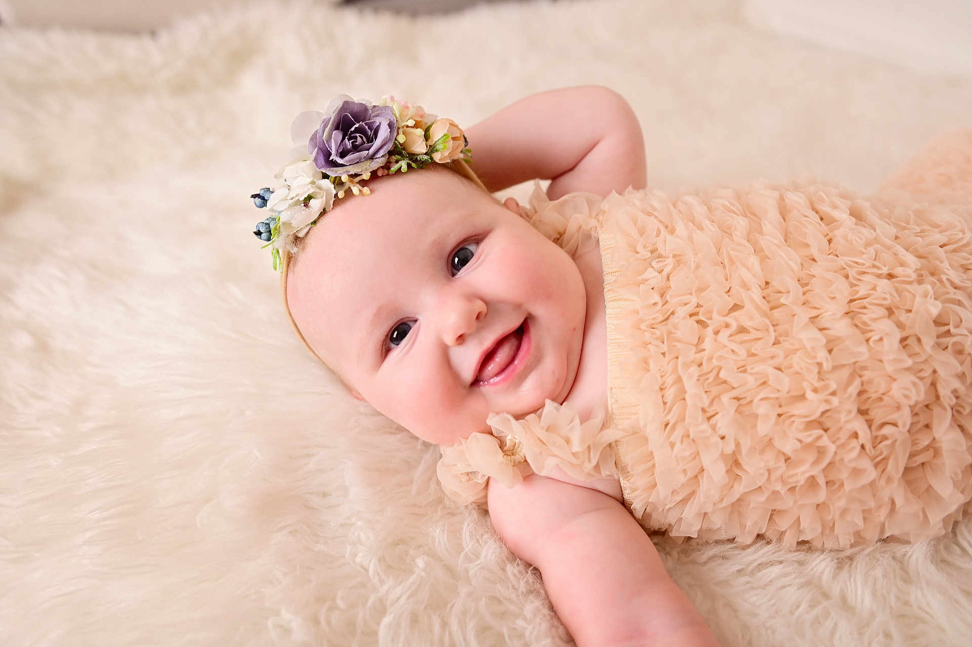 Bella joined the competition — help win amazing prizes! baby, infant, smiling, face, blanket, floral_headband, ruffled_dress, soft_texture, portrait, rosy_cheeks, lying_down, happy, newborn, adorable, closeup, studio_photography, cute, eye_contact, skin, person