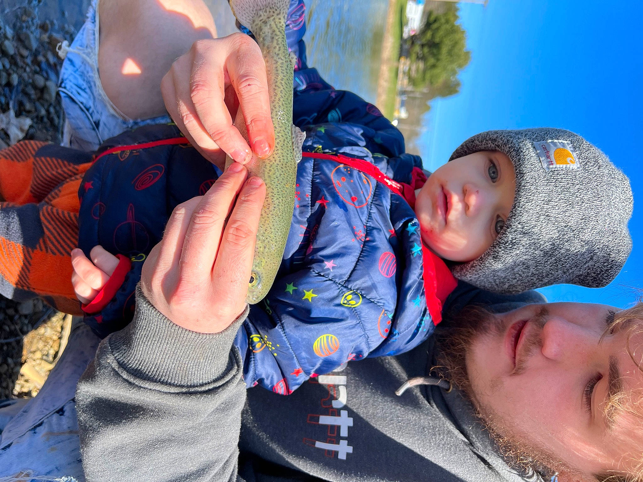 Waylon is registered to the contest to win money with this photo: baby, beanie, blue, cap, child, electric_blue, fun, gesture, grass, happy, headwear, knit_cap, leisure, nail, person, plant, recreation, sky, toddler, tree