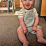 baby, bracelet, carpet, child, cute, face, feet, floor, furniture, happy, indoor, kitchen, legs, overalls, person, sitting, smiling, striped_shirt, toddler, wood