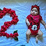 baby, infant, toddler, number_two, hibiscus, red_flowers, headband, bow, minnie_mouse, onesie, bandana, blanket, lying_down, portrait, cute, big_eyes, celebration, soft_lighting, skin, hand