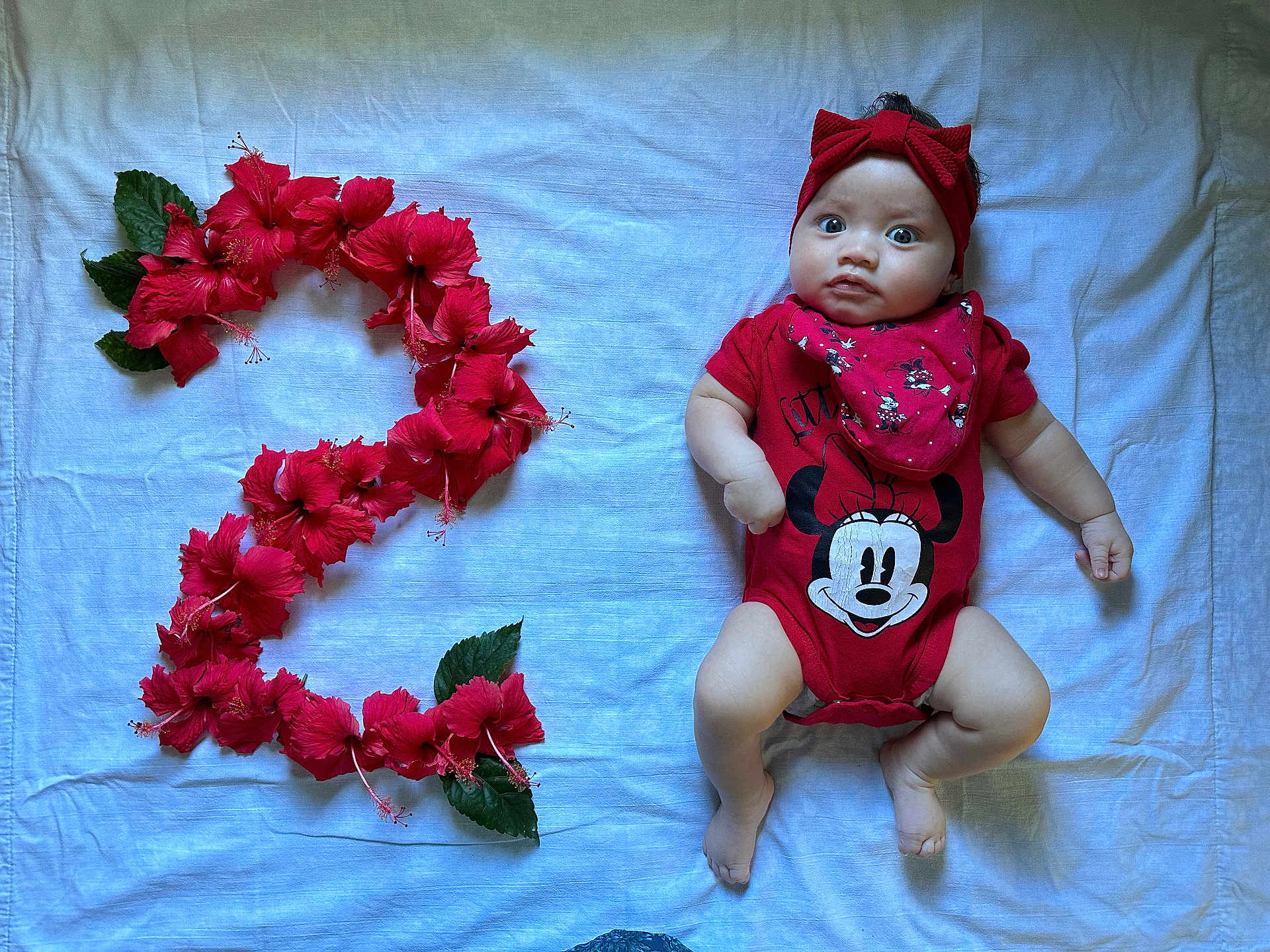 Tepootunuiohiva a rejoint le concours — aidez-le/la à gagner de superbes lots ! baby, infant, toddler, number_two, hibiscus, red_flowers, headband, bow, minnie_mouse, onesie, bandana, blanket, lying_down, portrait, cute, big_eyes, celebration, soft_lighting, skin, hand
