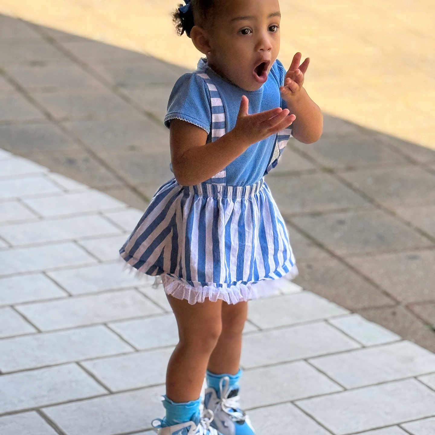 Jaycee joined the competition — help win amazing prizes! blue_dress, blue_socks, casual_clothing, child, cute, daylight, emotion, full_body, girl, hair_bow, outdoor, pavement, person, short_hair, sidewalk, sneakers, standing, striped_dress, surprised_expression, young