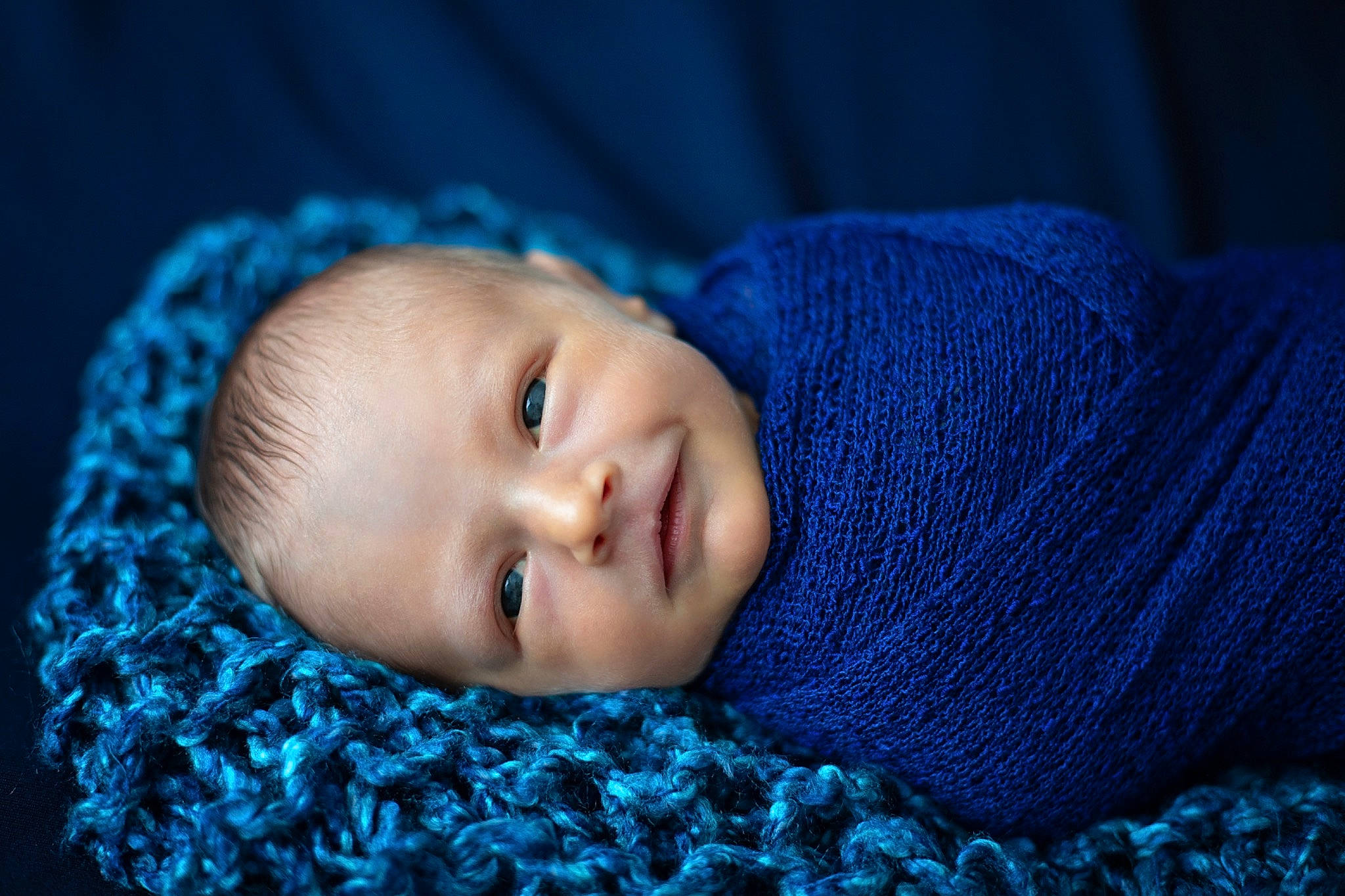 Mac is registered to the contest to win money with this photo: baby, blue, cheek, child, close_up, eye, face, head, knitting, lip, nose, person, photograph, photography, portrait_photography, skin, sky, sleep, smile, textile