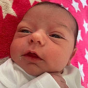 Ruby-Leigh is registered to the contest to win money with this photo: baby, newborn, infant, face, skin, eyes, hand, white_clothing, blanket, pattern, stars, closeup, portrait, cute, sleepy, resting, soft, child, young, indoors