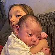 Ruby-Leigh joined the competition — help win amazing prizes! arm, baby, child, couch, cozy, face, family, indoor, infant, neutral_background, person, portrait, resting, sibling, sleepy, soft_lighting, tender_moment, wearing_clothes, young_child, young_infant