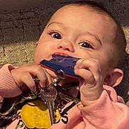 Ruby-Leigh joined the competition — help win amazing prizes! baby, child, keys, pink_sweater, hand, face, curious, indoor, chewing, young_child, closeup, portrait, holding, fingers, expression, infant, person, toy, texture, casual_clothing