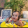 Catalina is registered to the contest to win money with this photo: baby, inflatable, pool, water, yellow, float, child, outdoor, plants, signboard, text, summer, smiling, face, hand, bucket, toy, background, nature, fun
