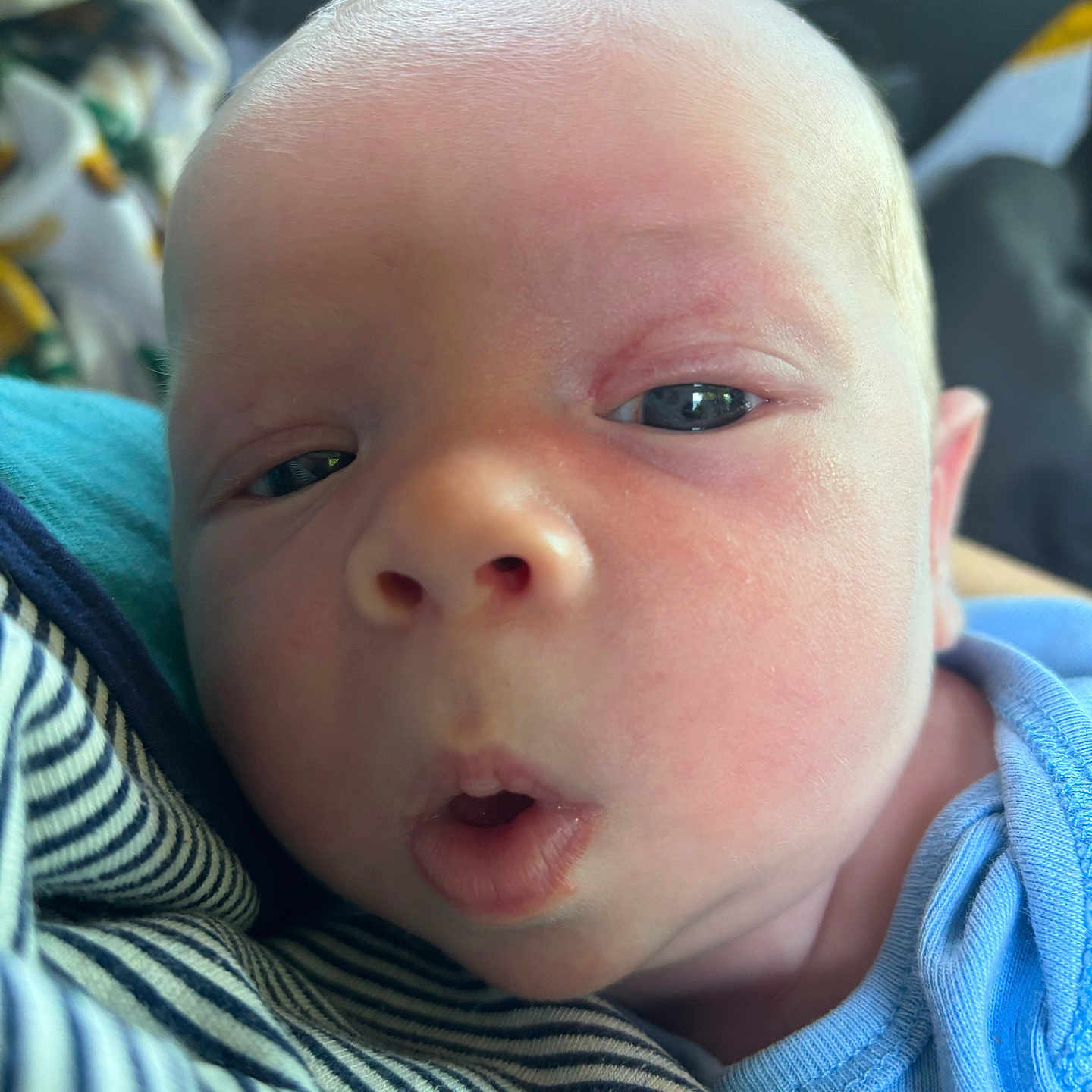 Stewart is registered to the contest to win money with this photo: baby, blue_clothing, child, closeup, cute, detail, expression, face, head, human, indoors, infant, mouth, newborn, person, portrait, skin, small, soft_light, striped_fabric