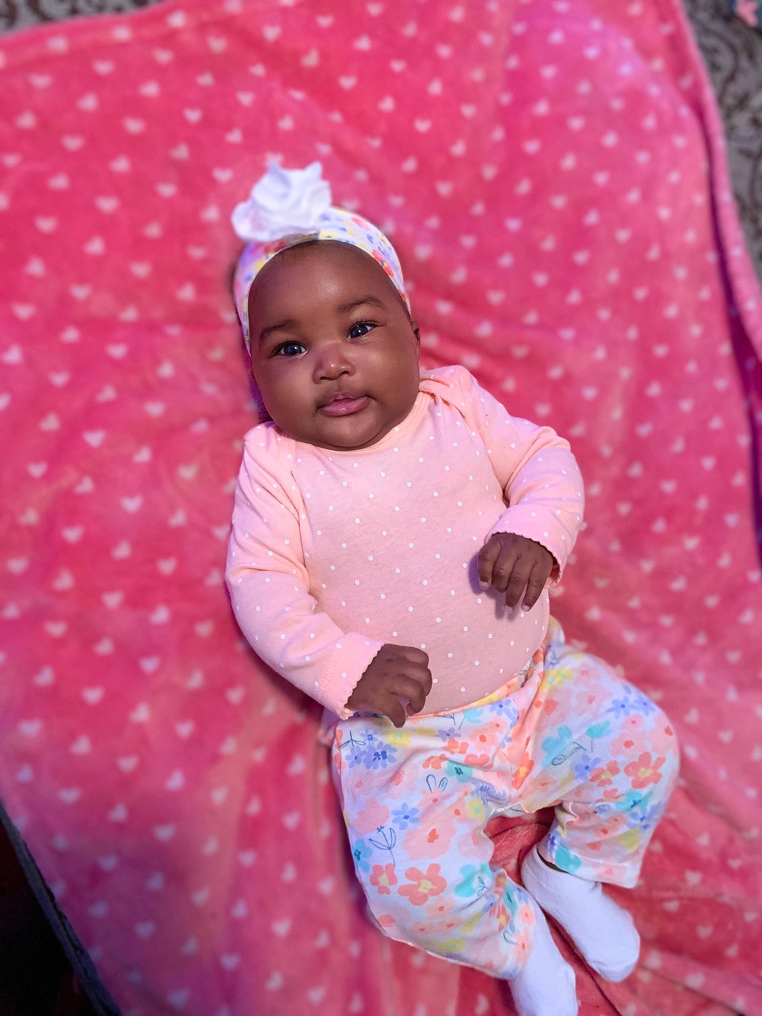 Khalani joined the competition — help win amazing prizes! baby, baby_products, baby_toddler_clothing, bonnet, linens, pattern, peach, person, pink, polka_dot, sock