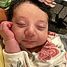 Charlotte is registered to the contest to win money with this photo: newborn, baby, infant, sleeping, portrait, face, bow, headband, floral_blanket, swaddled, hand, cheek, closed_eyes, peaceful, indoors, close_up, soft_lighting, couch, bottles, cute