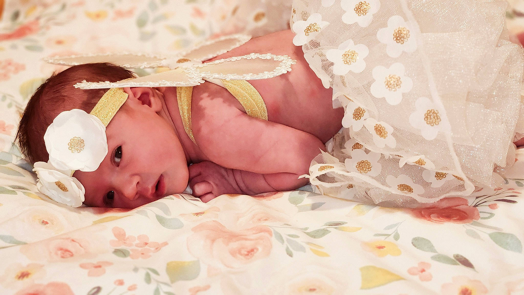 Melody is registered to the contest to win money with this photo: baby, baby_products, baby_sleeping, baby_toddler_clothing, child, comfort, embellishment, fashion_accessory, hair_accessory, headband, headgear, headpiece, headwear, linens, pattern, peach, person, petal, pink, skin