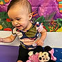 baby, toddler, child, smiling, sitting, plush_toy, minnie_mouse, colorful_background, wall_art, onesie, shorts, indoor, playtime, cute, happy, portrait, hair, cheek, arm, toy
