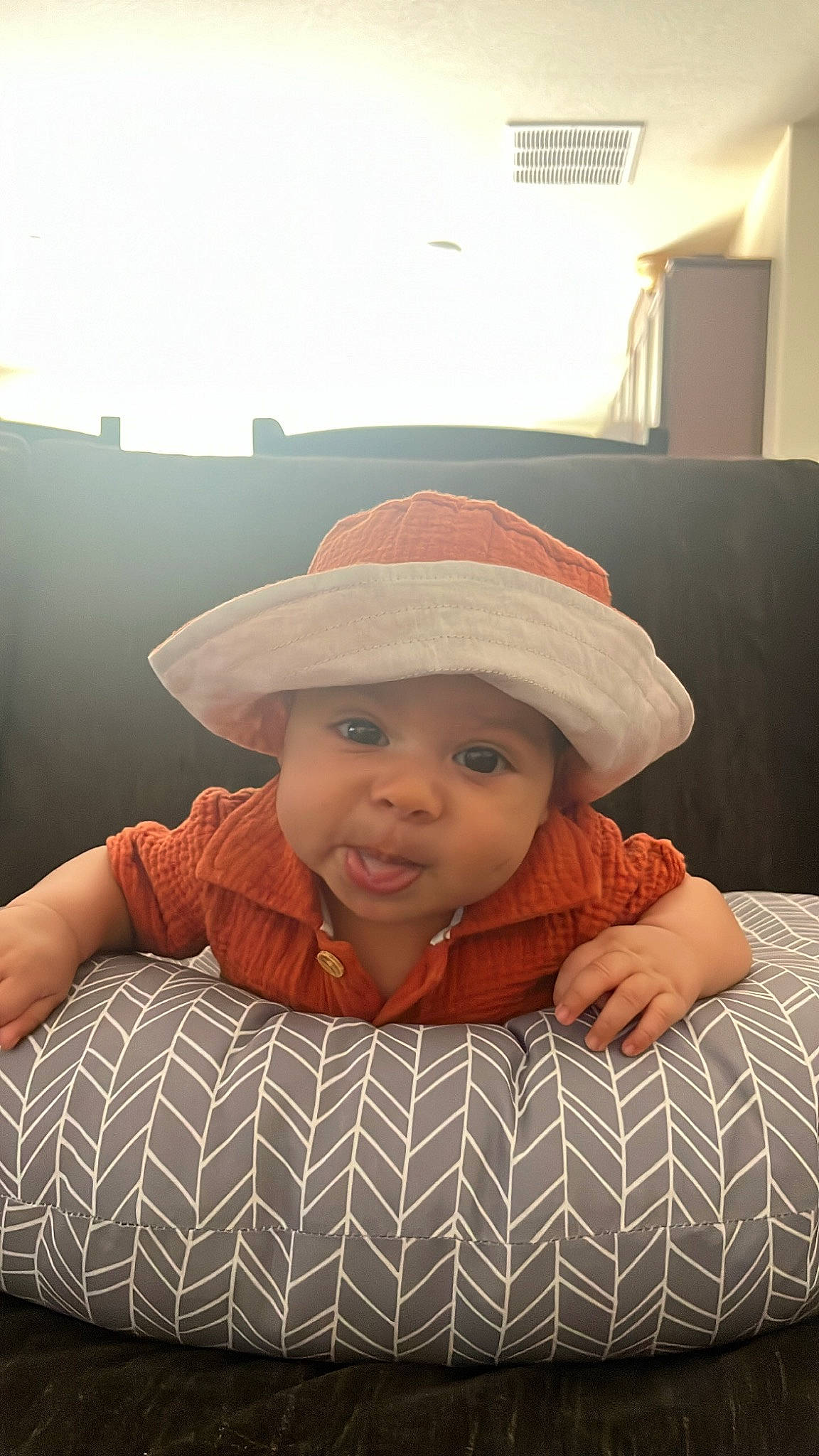 Cyrus is registered to the contest to win money with this photo: baby, baby_toddler_clothing, cap, cheek, child, chin, comfort, eye, fashion_accessory, flash_photography, happy, hat, headwear, lip, pattern, person, sitting, skin, sleeve, smile