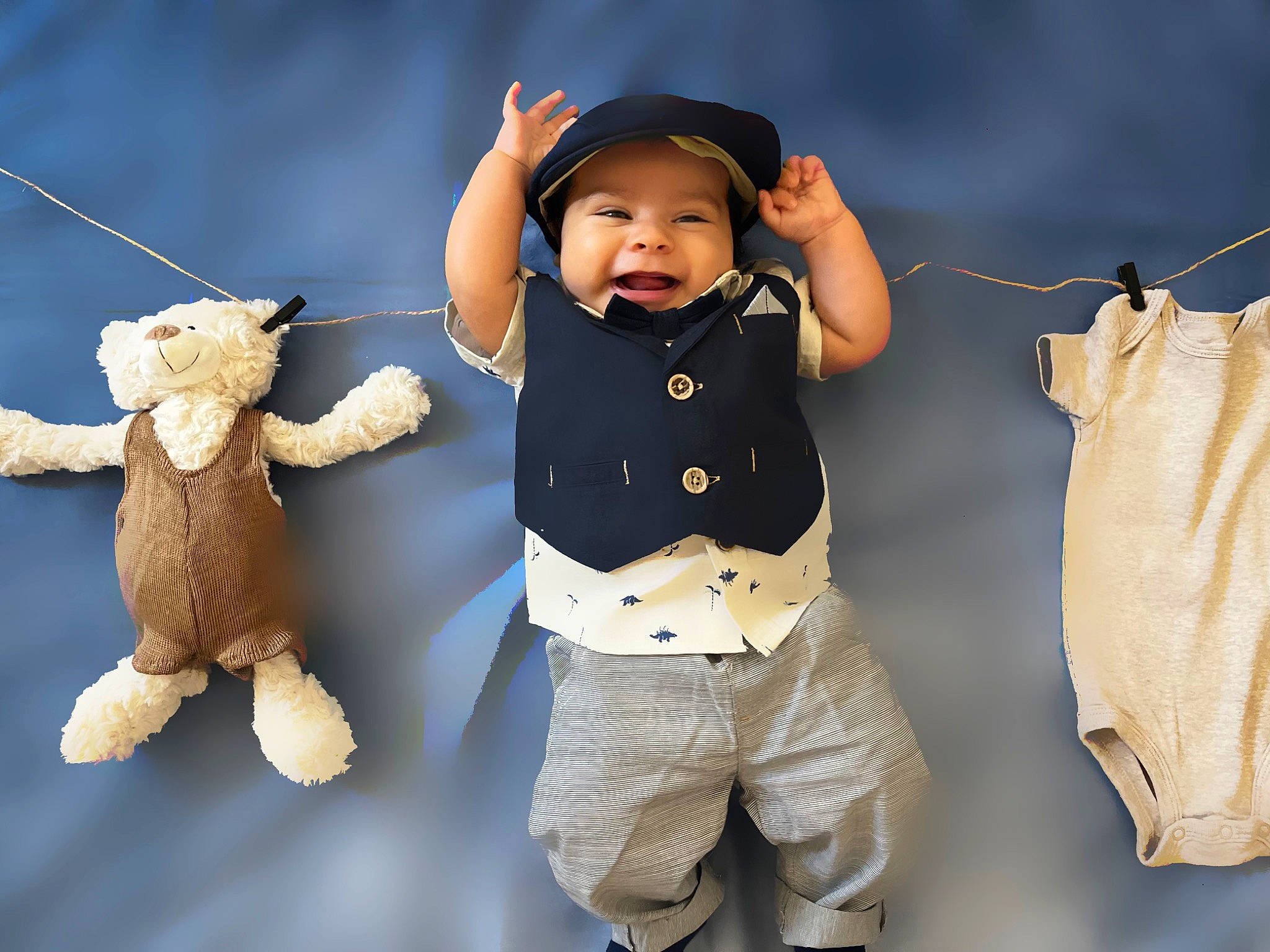 Cyrus is registered to the contest to win money with this photo: arm, baby, baby_toddler_clothing, flash_photography, gesture, hand, happy, headwear, human, human_body, mammal, outerwear, person, product, sleeve, smile, standing, textile, toddler, toy