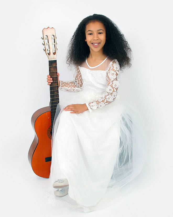 Amber joined the competition — help win amazing prizes! acoustic_guitar, black_hair, dress, electric_guitar, guitar, guitarist, joy, long_hair, musical_instrument, musician, person, photo_shoot, plucked_string_instruments, sitting, string_instrument, style, white