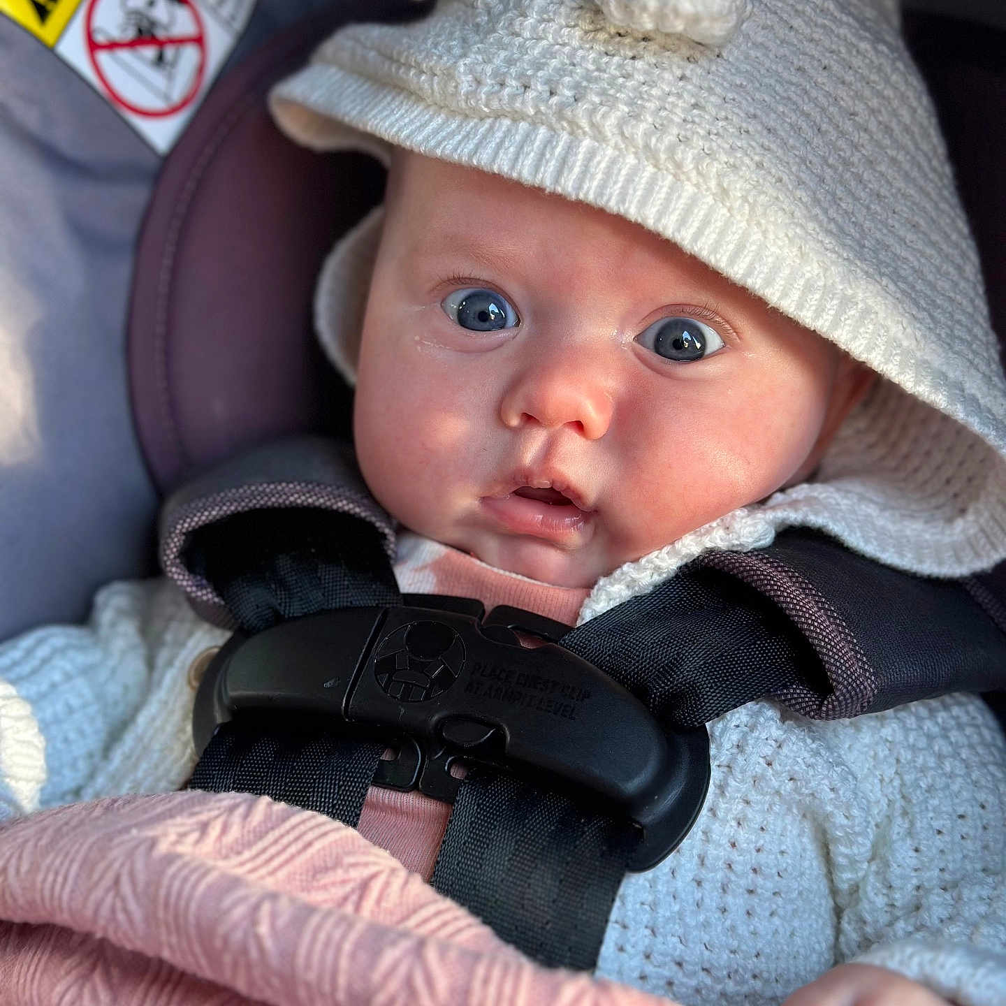 Norah joined the competition — help win amazing prizes! baby, bodypart, bonnet, cap, clothing, coat, face, finger, gun, hand, hat, head, jacket, knitwear, person, photography, portrait, sweater, transportation, weapon