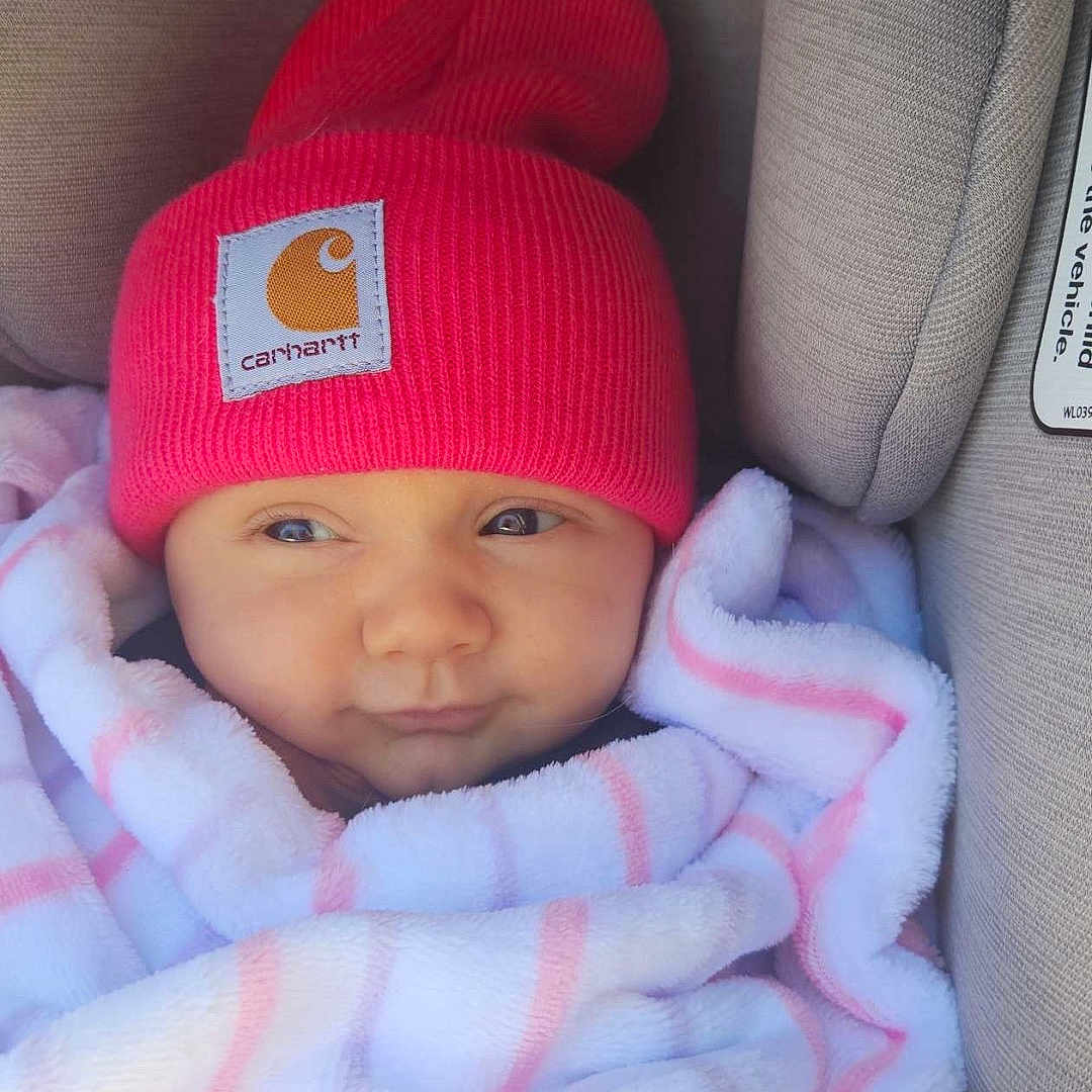 Josie is registered to the contest to win money with this photo: baby, bed, blanket, cap, car, clothing, cushion, face, furniture, happy, hat, head, homedecor, newborn, person, photography, portrait, sleeping, smile, transportation