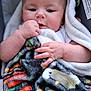 baby, infant, blanket, hand, face, skin, cute, child, cozy, soft, warm, colorful, pattern, portrait, expression, young, wrapped, indoors, comfort, clothing