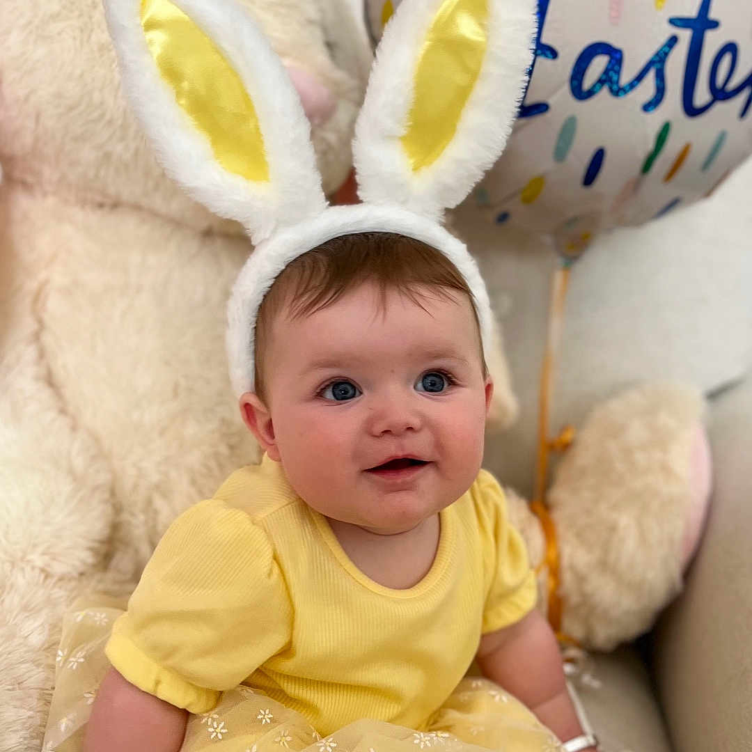 Dilorie joined the competition — help win amazing prizes! baby, balloon, bunny_ears, celebration, child, couch, cute, easter, face, festive, holiday, indoor, person, plush_toy, sitting, smiling, soft_toys, tights, white_shoes, yellow_dress