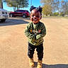 Jaderrion is registered to the contest to win money with this photo: child, smiling, outdoor, sunny, green_sweatshirt, black_pants, boots, shadow, trees, parked_cars, pavement, hairstyle, happy, person, daylight, casual_clothing, standing, portrait, playful, young