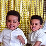 toddler, child, smiling, white_shirt, sneakers, sitting, floor, gold_backdrop, happy, portrait, cute, indoor, two_children, curly_hair, casual_clothing, playful, young, people, friends, joy