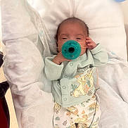 Psalms is registered to the contest to win money with this photo: baby, infant, pacifier, clothing, cute, sleepy, lying_down, blanket, hospital, foot, onesie, person, newborn, soft, cute_outfit, animal_print, nursery, child, resting, cozy