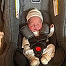newborn, baby, car_seat, infant, sleeping, clothing, hat, pajamas, straps, buckle, fabric, seat, child, person, cozy, cute, small, resting, indoors, safety