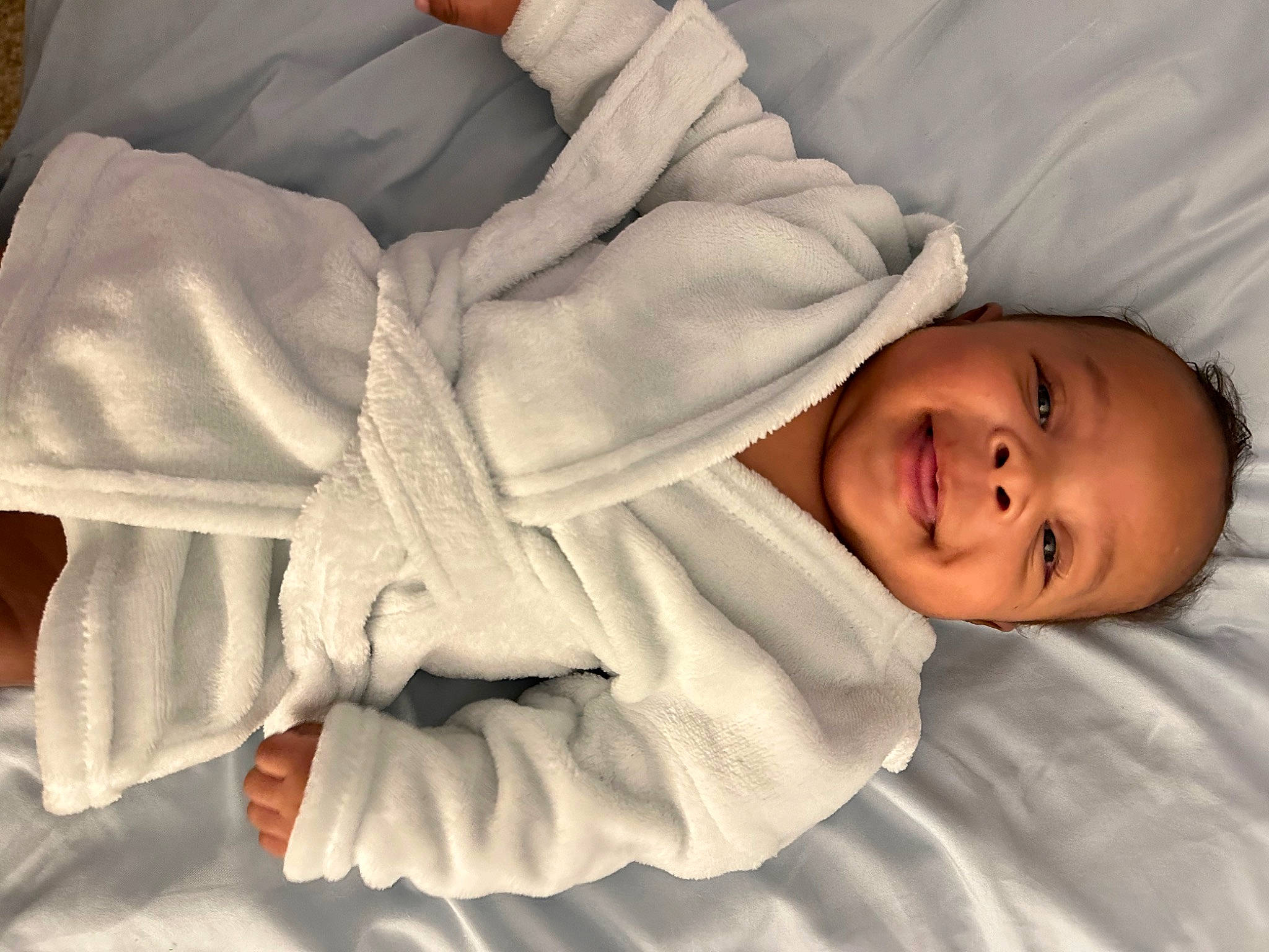 Jaylin is registered to the contest to win money with this photo: baby, baby_toddler_clothing, child, comfort, elbow, facial_expression, gesture, happy, joy, linens, mammal, nose, outerwear, person, product, room, skin, sleeve, smile, textile