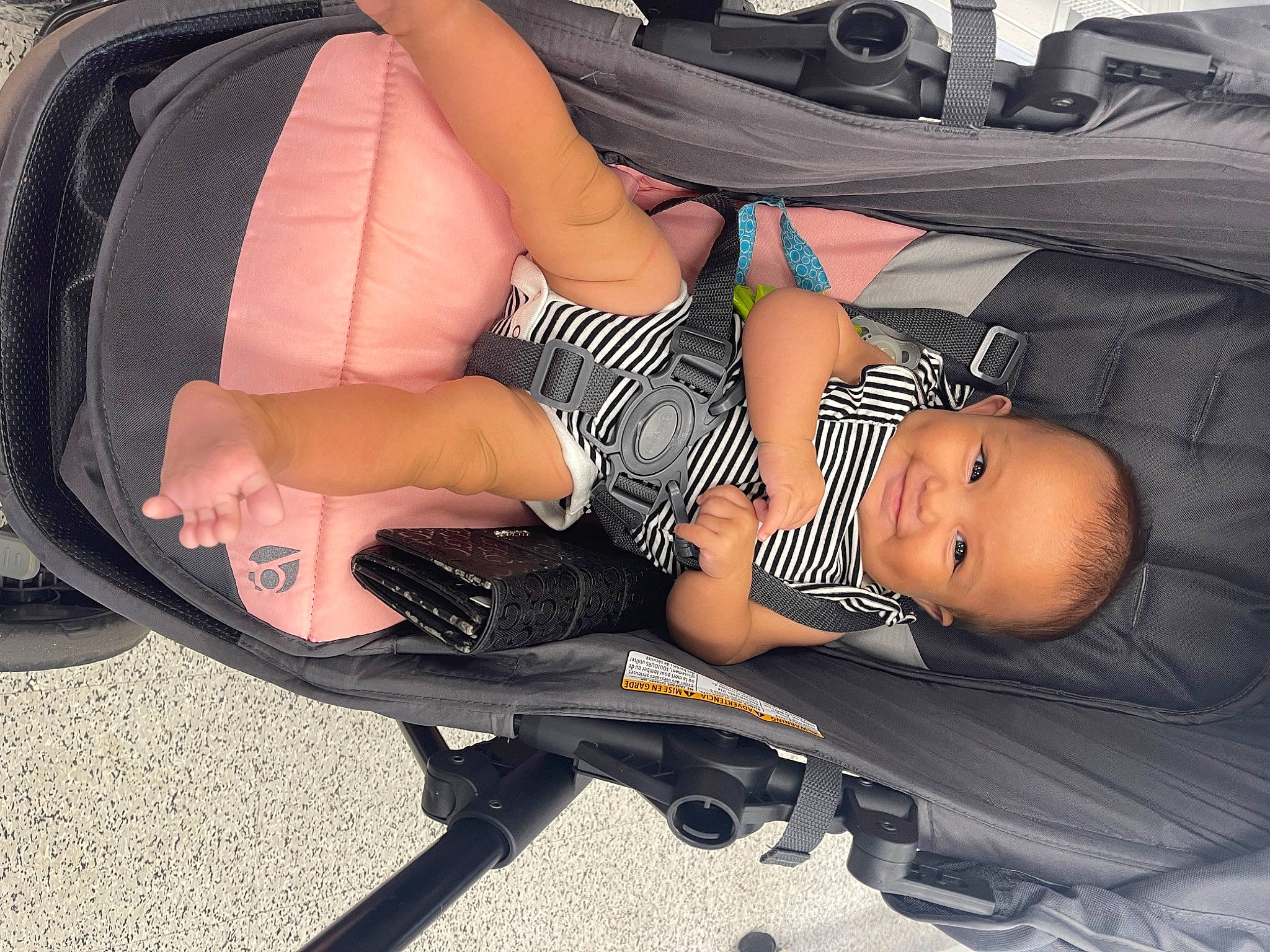 Kailani-khayzlee is registered to the contest to win money with this photo: arm, automotive_design, baby_products, black_hair, chest, comfort, dress, face, hand, human_body, human_leg, joint, knee, leg, muscle, person, shoe, shorts, sitting, sunglasses