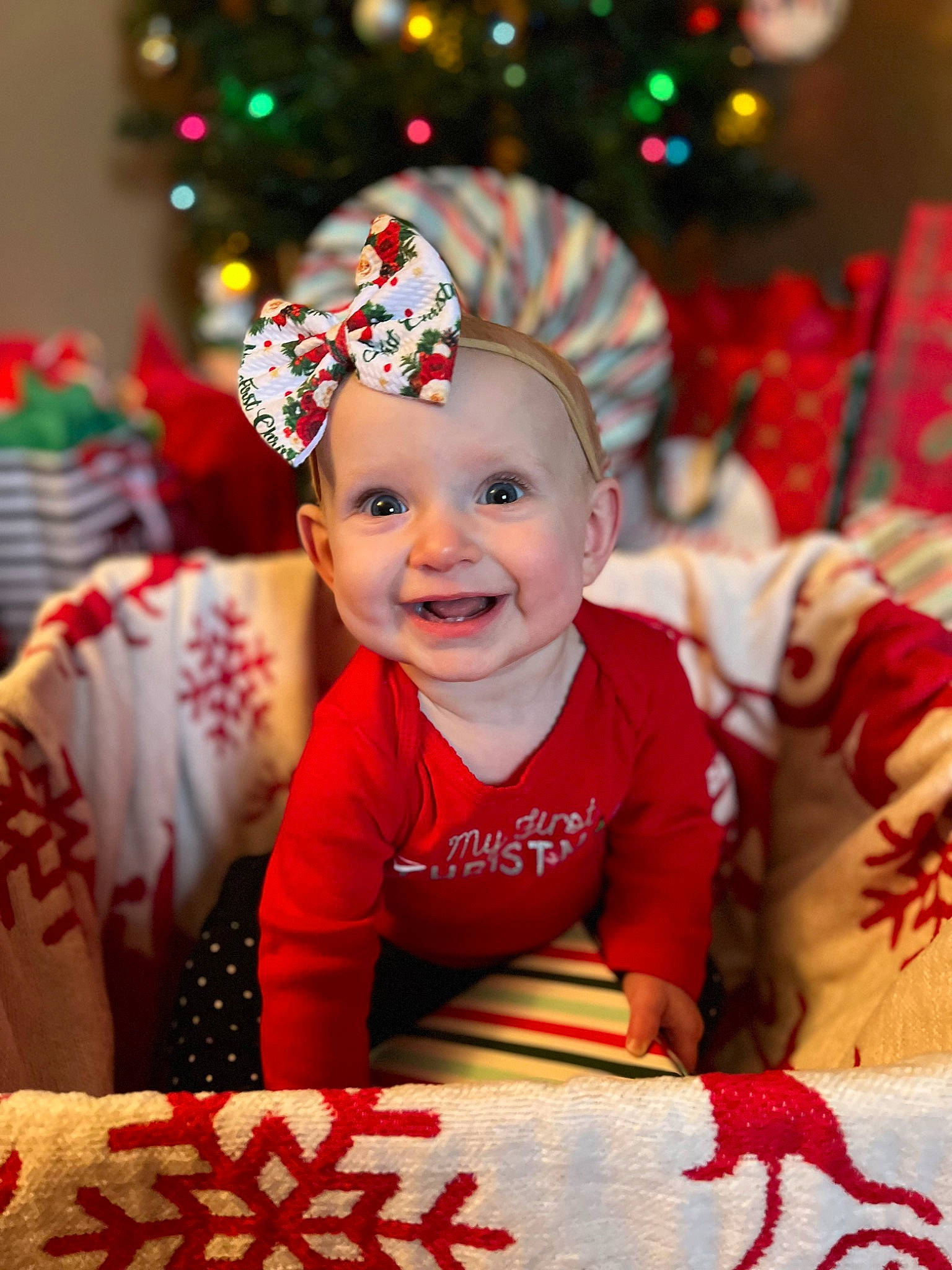 Alanah is registered to the contest to win money with this photo: baby, baby_toddler_clothing, christmas_tree, event, eye, face, fun, green, happy, hat, head, holiday, human_body, joy, light, lighting, person, photograph, red, smile