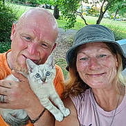 Pookie joined the competition — help win amazing prizes! man, woman, kitten, cat, outdoor, park, greenery, smile, selfie, happy, nature, trees, summer, casual_clothing, hat, bracelet, necklace, tattoo, pet, animal