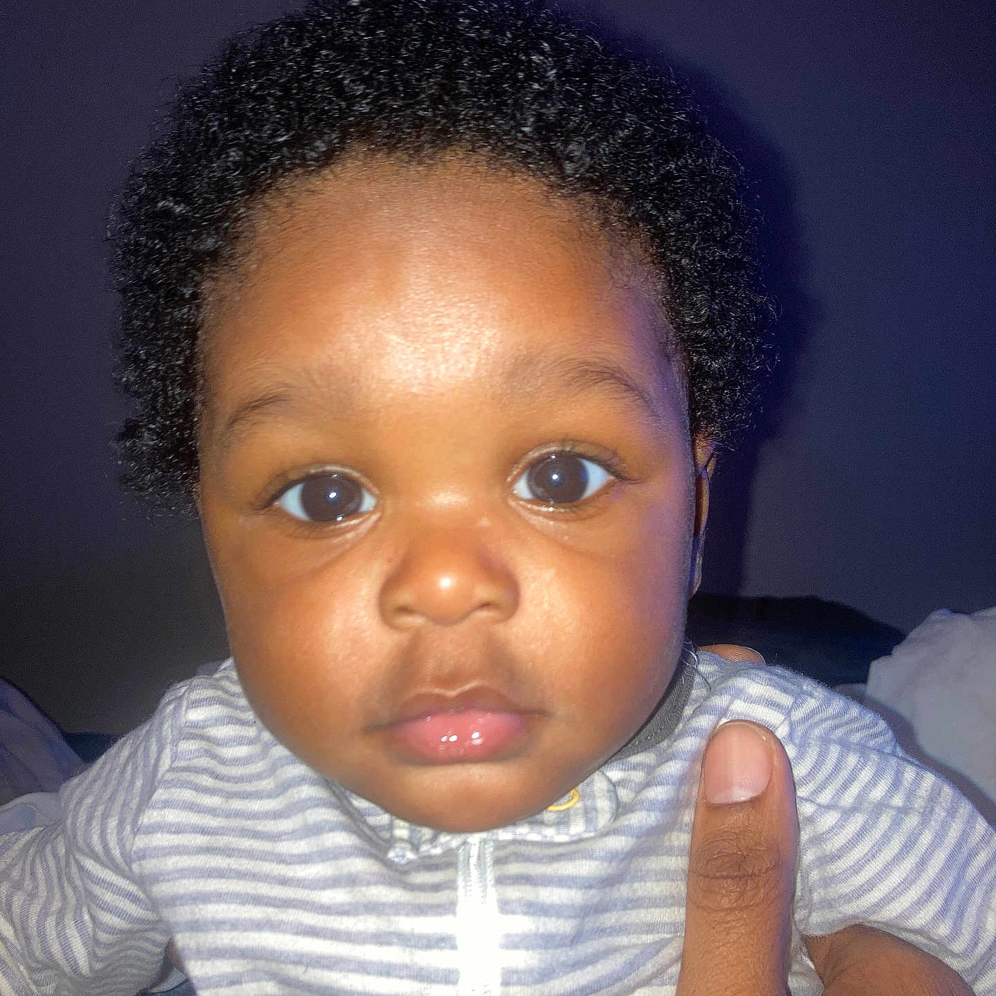 Marcus is registered to the contest to win money with this photo: accessories, baby, blackhair, bodypart, clothing, face, finger, frown, hair, hand, happy, head, jewelry, mouth, person, photography, portrait, sad, shirt, smile