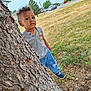 boy, car, child, clothing, face, footwear, head, hiding, jeans, male, pants, person, photography, plant, portrait, shoe, transportation, tree, treetrunk, vehicle