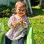 Ivanna a rejoint le concours — aidez-le/la à gagner de superbes lots ! toddler, child, smiling, outdoor, slide, greenery, sunlight, toy, playground, grass, casual_clothing, happy, person, daylight, small_hands, ponytail, cute, sitting, pink_top, shoes